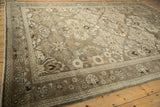 Distressed Bibikabad rug corner: muted beige, ivory, and pale blue floral border and soft pile.
