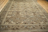 Distressed Persian Bibikabad rug border detail, showing floral cross-sections in soft beige and blue.