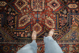 Hand-knotted vintage Heriz carpet pile with cherry red and navy blue Herati motifs.