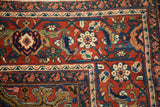 Vintage Heriz rug corner shows deep cherry red field, navy Herati and Turtle Samovar borders.