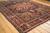 Deep cherry red and navy blue geometric palmettes on a vintage Heriz carpet.