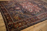 Vintage Heriz rug detail showing geometric Turtle Samovar border and floral motifs.