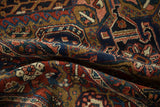Textured pile of the curled vintage Heriz carpet with rich cherry red and sapphire blue motifs.