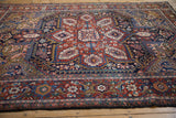 Cherry red and navy blue Herati motif with floral palmettes on the vintage Heriz rug.