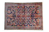 Vintage Persian Lilihan carpet with a triple medallion and scrolling arabesques on a dark sapphire blue field.