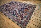 Corner view showing the meandering vine border and arabesques of a fine Lilihan carpet.