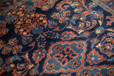 Detailed floral arabesques in red and copper tones across the sapphire blue field of a vintage Lilihan rug.