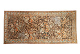 Vintage distressed Malayer runner with an allover floral pattern in tangerine, blue, and sand on a chocolate brown field.