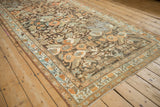 A perspective shot of the distressed Malayer runner's allover floral pattern and characterful wear.