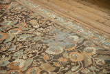 Heavy wear exposes the foundation, creating textural detail on the vintage Persian Malayer rug.