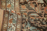 A folded view of the vintage Malayer rug highlights its textured weave and floral bouquets.