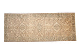 Distressed Persian Karaja runner with single column medallions in soft coffee brown, sand, and ivory tones.