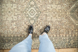 A personal overhead view of the geometric patterns and distressed low pile on a vintage Karaja rug runner.