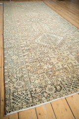 Distressed vintage Karaja runner seen from an angle, highlighting the central column of medallions.