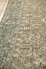Detail of a distressed Karaja runner's geometric patterns and even, low-pile wear in neutral tones.
