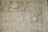 Distressed vintage Karaja rug's low pile showing even wear and faded geometric patterns in neutral tones.