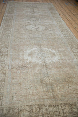 Distressed vintage Karaja runner with faded geometric patterns and visible foundation wear.