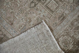 Distressed Karaja rug's worn geometric pile and woven foundation with intact side selvage.