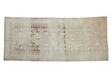 Distressed Oushak runner with faded Samovar style floral patterns in pale coffee brown and platinum.