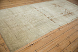 Side view of distressed Oushak runner showing faded Samovar florals with wear to knot heads.