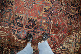 Hand-knotted vintage Heriz carpet, detailing geometric vines in dusty burgundy, navy, and teal.