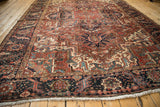 Vintage Heriz carpet border shows seeded meandering vine and floral top view.