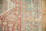 Mostly even wear on the Karaja rug's geometric border in pale brick red and jade green.