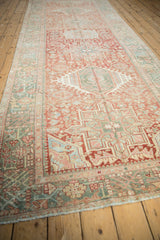 Angled perspective of the vintage Karaja runner's repeating geometric medallions and border.