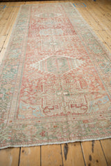 Angled perspective of the distressed Karaja runner showing its single column of faded medallions.