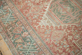 Faded brick red, jade green, and powder blue geometric patterns on a vintage Karaja rug runner.