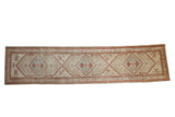 Vintage Serab runner with triple diamond medallions in powder blue and red on a distressed beige field.