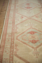 Angled view of a vintage Serab runner's pawn motif border and serrated diamond medallion.