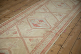 Angled perspective showing the low pile texture and repeating diamond medallions on a distressed Serab runner.