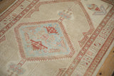 Low, even pile on a distressed Serab rug showing a powder blue and red geometric medallion.