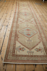 A long view of a vintage Serab runner showing the repeating diamond medallions.