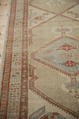 Angled view of a vintage Serab's detailed pawn motif border and distressed low-pile texture.