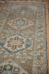 Distressed Heriz runner detail: geometric birds, palmette finials, meandering border, and worn pile.