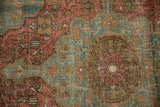 Distressed antique Farahan Sarouk rug, faded raspberry and ocean green floral motifs with exposed foundation.