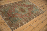 Corner of distressed Farahan Sarouk rug, bell-shaped arabesque border, faded blush, ocean green.