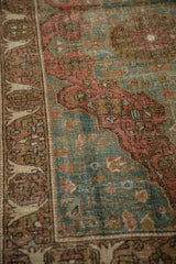 Decorative distressed pile and bell-shaped arabesque border of an antique Farahan Sarouk.