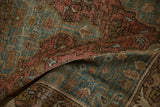 Worn pile of antique Farahan Sarouk, showing faded raspberry, ocean green, and coffee brown motifs.