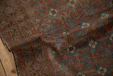 Distressed vintage Belouch runner showcasing geometric guls, dusty blue, ruby red, and visible foundation.