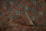 Distressed Belouch rug showing worn geometric pile, visible foundation, and selvage.