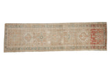Vintage distressed Karaja runner, soft beige tones, geometric medallions, and striking brick red end.