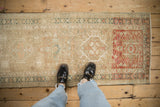 Distressed vintage Karaja rug showing abrash, geometric medallion, and dye lot change.