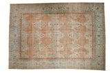 Distressed vintage Kashan carpet, dusty rose field, ribbon cloudbands, and colorful vine borders.