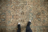 Distressed texture of a vintage Tabriz carpet, showing the low pile and pale sky blue patterns.