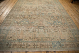 A lengthwise view of a distressed Tabriz carpet with a worn texture and a soft pale blue and beige palette.