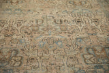 Low-pile texture of a vintage Tabriz showing the time-softened weave and pale blue floral details.
