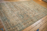 Angled perspective of a vintage Tabriz rug, highlighting its decorative low-pile wear and soft coloration.